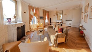 A spacious living room with a fireplace, a sofa set, and a dining area. - ST GERMAIN, BALCONY, VIEW, 2 BATHS, 30–60 days ahead? Private offer. BEV-VBs (Paris)