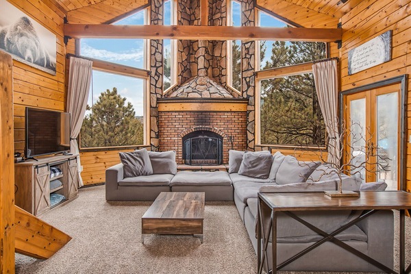 Living room with smart TV and wood burning fireplace of cabin #1