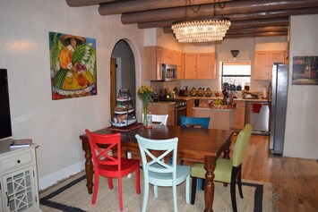 View of eating area plus kitchen.