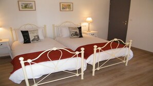 A double bed with a red blanket, two bedside tables with lamps, and two wall-mounted pictures. - 3 The Courtyard Award Winning 4 Star Vineyard Gite (Monbadon)