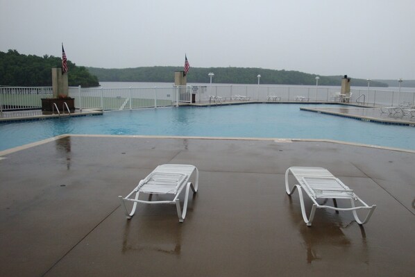 Relax by the pool surrounded by a serene natural backdrop.