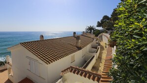 Ein Küstengebäude mit Ziegeldach mit Blick auf das Meer.