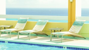 A poolside area with lounge chairs and a view of the ocean. - The Best Rate Ever!! Pacific Monarch Partial Ocean View Room!! (PM04) (Honolulu)