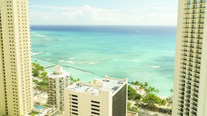 A high-rise hotel overlooking a beach with clear turquoise waters and a view of the ocean. - The Best Rate Ever!! Pacific Monarch Partial Ocean View Room!! (PM04) (Honolulu)