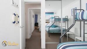 Une chambre d’hôtel avec des lits superposés, une télévision et une vue sur la ville.