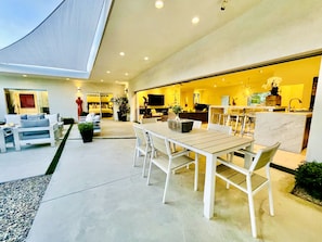 A modern interior with a dining area, kitchen, and living space.