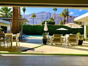 Relax by the pool surrounded by a serene mountain view and lush greenery.