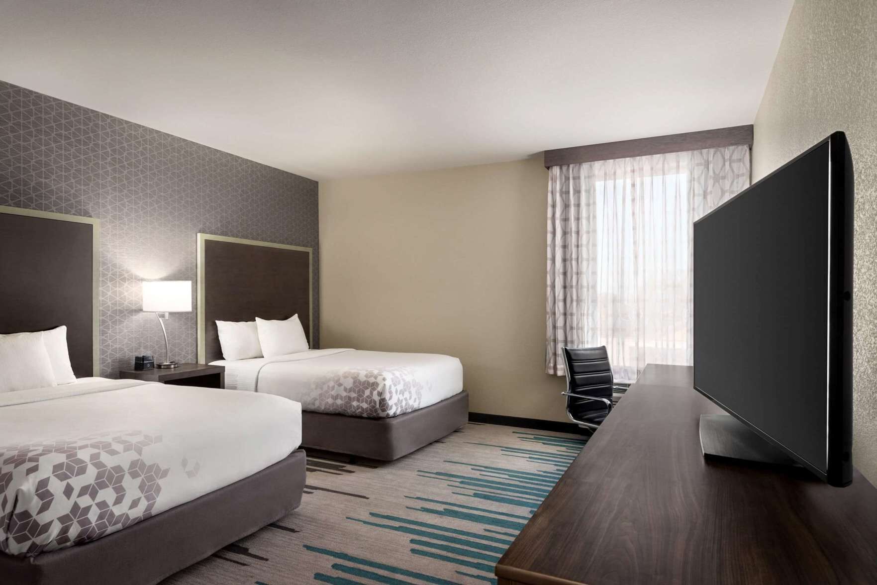 Premium bedding, pillow-top beds, desk, laptop workspace