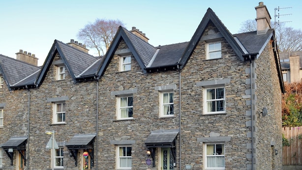 A row of stone houses with pitched roofs and multiple windows. - 3 bedroom accommodation in Ambleside (Ambleside)