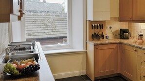 A kitchen with a sink, countertop, and a window. - 3 bedroom accommodation in Keswick (Keswick)