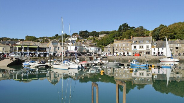 A harbor with boats docked, a café, and buildings along the waterfront. - 5 bedroom accommodation in Newquay (Newquay)