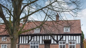 A traditional half-timbered house with a brick facade, white timber framing, and a tiled roof. - 4 bedroom accommodation in Easingwold, near York (Easingwold, near York)