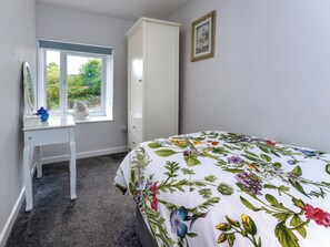A bedroom with a bed, a dresser, a window, and a framed picture on the wall. - 2 bedroom accommodation in Salterforth, near Barnoldswick (Salterforth, near Barnoldswick)