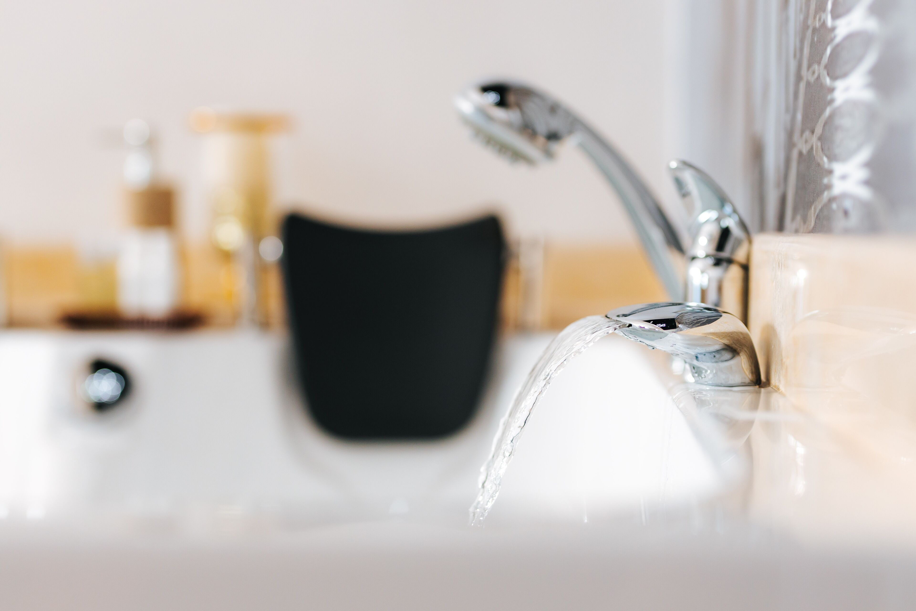 A bathroom sink with a modern faucet and a mirror.