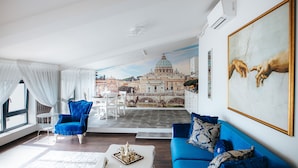 A living room with a blue sofa, a white coffee table, and a blue armchair. There is a large painting on the wall and a mural of a cityscape in the background. - Evianne Boutique Hotel (Galati)