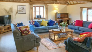 A cozy living room with two sofas, a coffee table, and a television. - 5 bedroom accommodation in Bromyard, near Malvern Hills (Bromyard, near Malvern Hills)