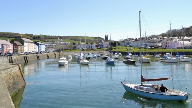 A harbor with boats docked, a church in the background, and houses along the shore. - 3 bedroom accommodation in Llangeitho, near Tregaron (Llangeitho, near Tregaron)