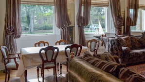 A dining area with a table set for four, surrounded by wooden chairs.