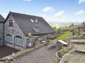 A stone building with a sloped roof, a chimney, and a small window. - 3 bedroom accommodation in Rothbury (Rothbury)