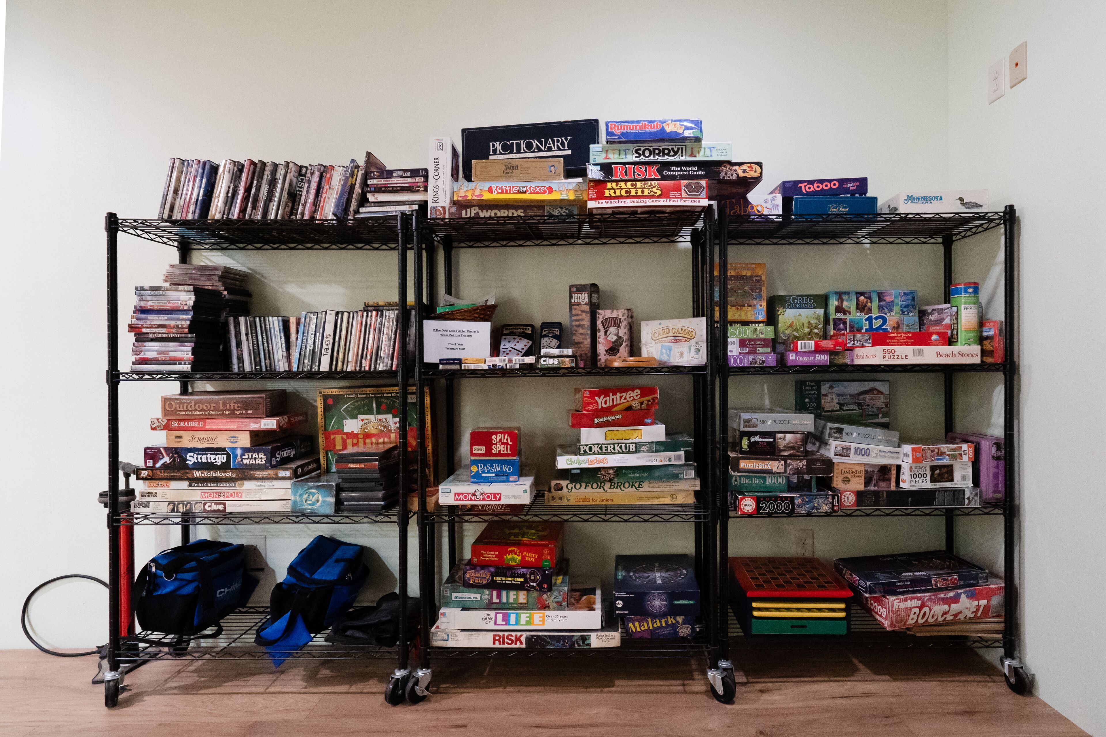 A bookshelf filled with various board games and books.