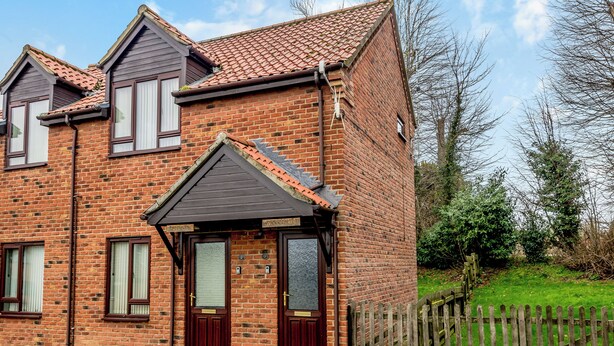 A two-story brick house with a dark roof, two front doors, and a small porch. - 1 bedroom accommodation in Horsford, near Norwich (Horsford, near Norwich)