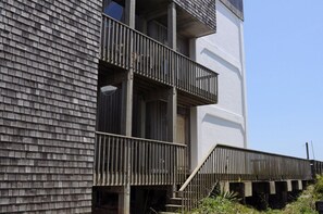 A multi-story building with a wooden facade and balconies.