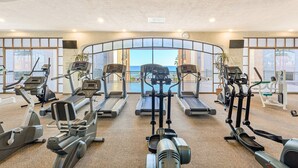 A gym with treadmills, ellipticals, and weight machines, overlooking a scenic view. - Sonoran Sea E-401 Feeling tip' Sea In Paradise Bright Oceanfront Condo (Puerto Peñasco)