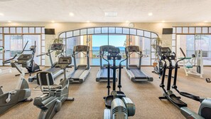 Una palestra con tapis roulant, ellittiche e macchinari per pesi, con vista su un panorama suggestivo.