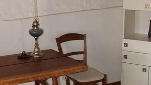A room with a wooden desk, a chair, a lamp, a framed picture on the wall, and a cabinet. - Logis in the chateau enclosure (Paizay-Naudouin-Embourie)