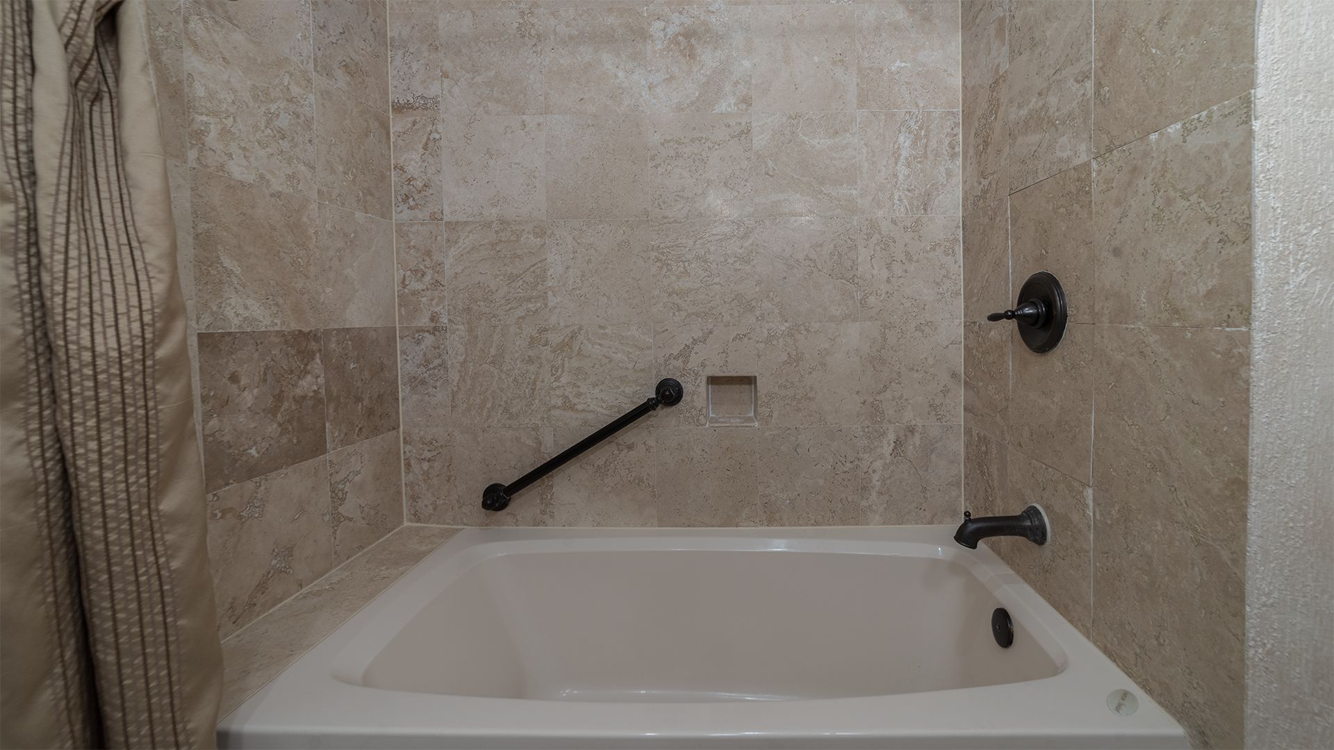 Une salle de bain avec une baignoire, un rideau de douche et un porte-serviettes.