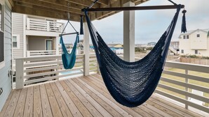 A wooden deck with a hammock and a balcony railing. - 4746- Sandy Feet Retreat - Oceanside Kitty Hawk Retreat w/ Pool (Kitty Hawk)
