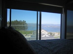 Enjoy a serene view of the water and distant landscape from this room's large window.