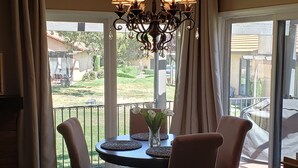 A dining area with a chandelier, a round table, and chairs. - Mountain Home Stallion Springs Ca. Luxury accommodation with Incredible views.  (Tehachapi)
