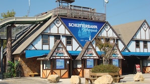 A traditional German-style building with a sign for 'Schlitterbahn Waterpark' established in 1979.