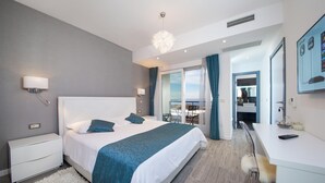 A modern hotel room with a large bed, a desk, a bathroom, and a balcony with a view. - Luxury Villa Blue Silk with Heated Pool (Makarska)