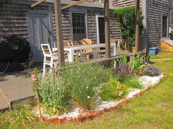 Enjoy dining on the deck. There is a table, bench seating, chairs and gas grill