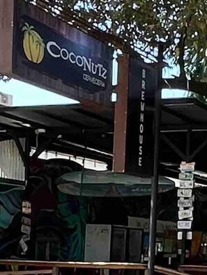 A storefront with a sign reading "Coconutz" and "BREWHOUSE". - Newly Remodeled Condo MS #1 With 200MB Internet (Coco)