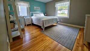 A bedroom with a bed, nightstand, dresser, and a ceiling fan. - ☆Oakley's Oasis, a Dharma Dwellings Designed Home☆ (Rochester)
