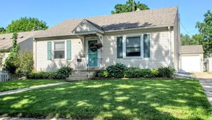 A single-story house with a front porch, a small front yard, and a mailbox. - ☆Oakley's Oasis, a Dharma Dwellings Designed Home☆ (Rochester)