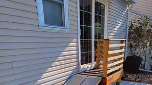 A house with a wooden porch and a ramp leading to the entrance. - ☆Oakley's Oasis, a Dharma Dwellings Designed Home☆ (Rochester)
