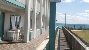 A beach resort sign with a bird logo and a sign indicating guest-only access.