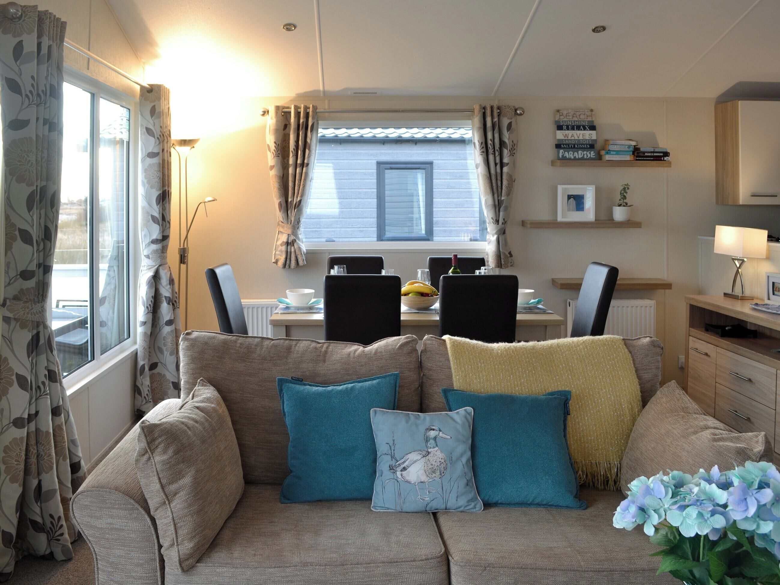 A cozy living area with a sofa, a dining table, and a kitchen area.