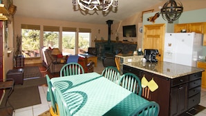 A spacious living room with a dining area, kitchen, and a fireplace. - Cabin, Dog Friendly, Hot Tub, Views, 6 acres, Wheelchair Accessible (Florissant)