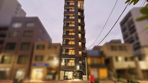 A multi-story residential building with balconies, a ground entrance, and a visible mail slot. - TOKYO Condominiun HOTEL ASAKUSA EIGHT (Tokyo)