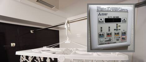A bathroom with a white towel rack and a sign that reads "Bathroom Dryer".