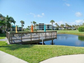 Escape to a serene lakeside haven with a tranquil atmosphere and a picturesque wooden bridge.