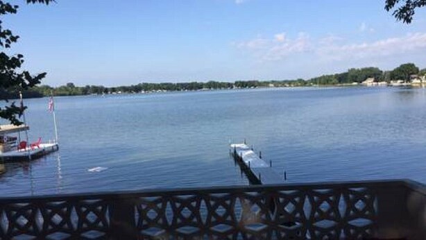 A view of a lake with a dock and a pier extending into the water.