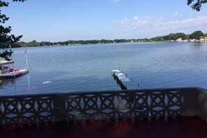 A view of a lake with a dock and a pier extending into the water. - LAKE FRONT COTTAGE ON IYOPAWA ISLAND GOLF COURSE (Coldwater)