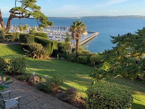 A marina with boats, a pier, and a grassy area with trees and shrubs. - Stunning views across Torbay with private gardens and a terrace to relax in. (Torquay)