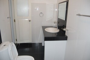 A bathroom with a toilet, sink, and mirror. - Siloonaa Garden Villa (Wariyapola)